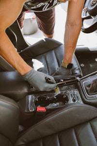 a man cleaning the interior of a car