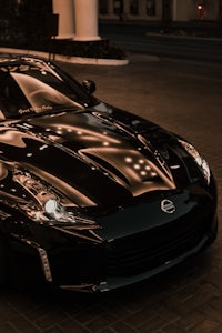 a black nissan sports car parked on a street