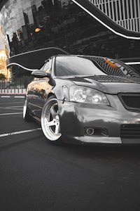 a silver car parked in front of a building